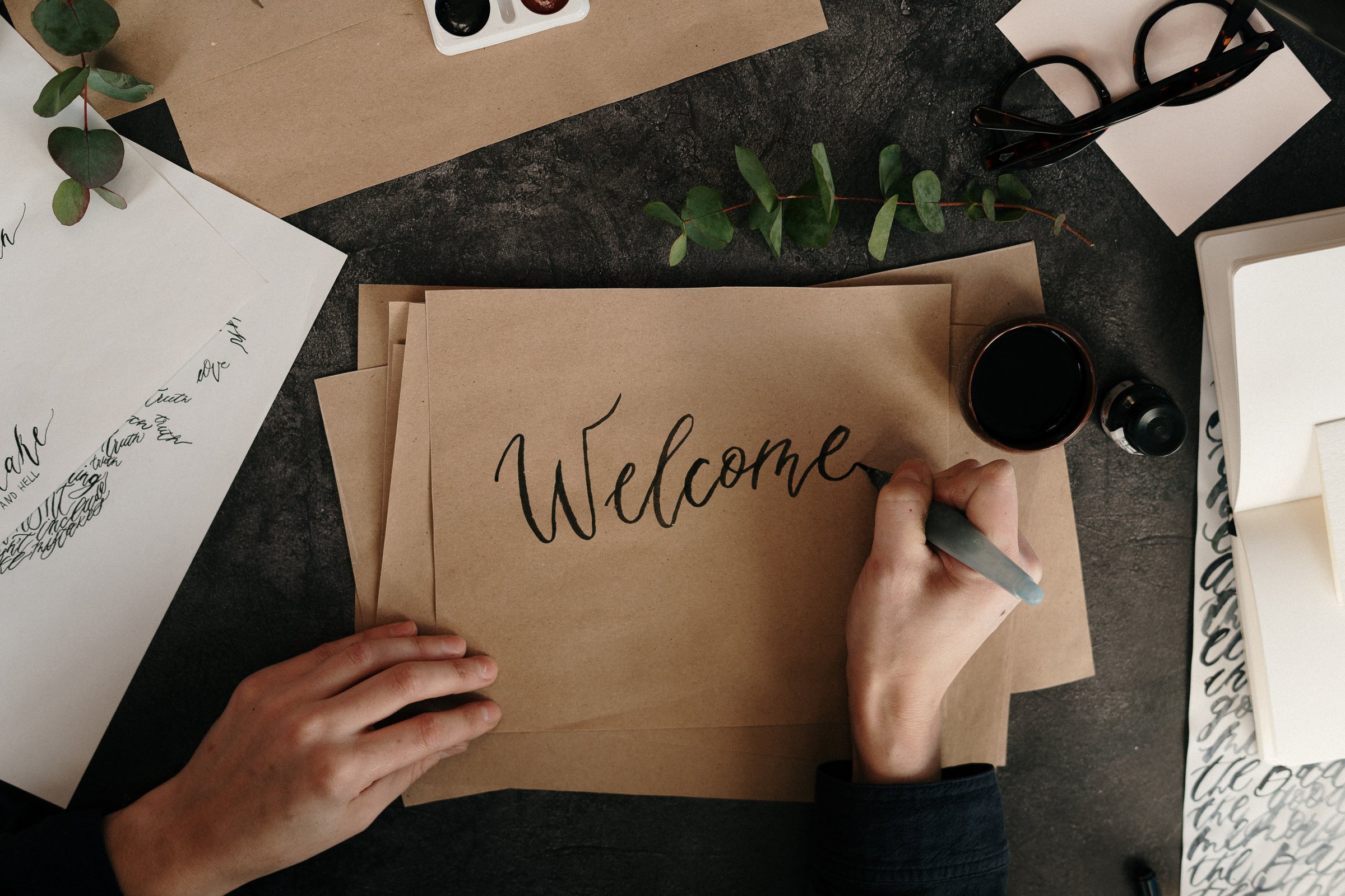 Person Writing On Brown Paper